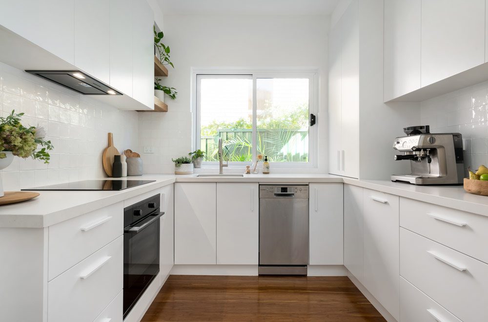U Shaped Kitchen - White Flush Kitchen Cabinets And Modern Appliances